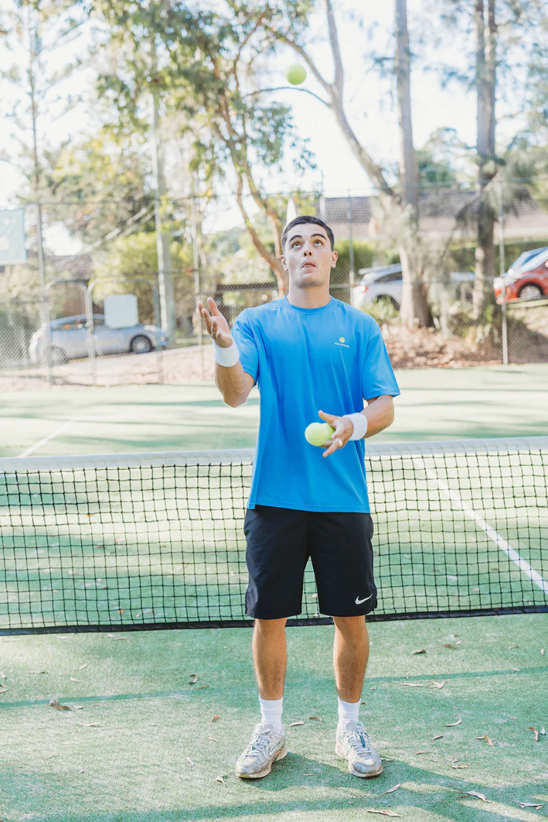 Lightweight Blue Tee in Tennis Court - Image 5